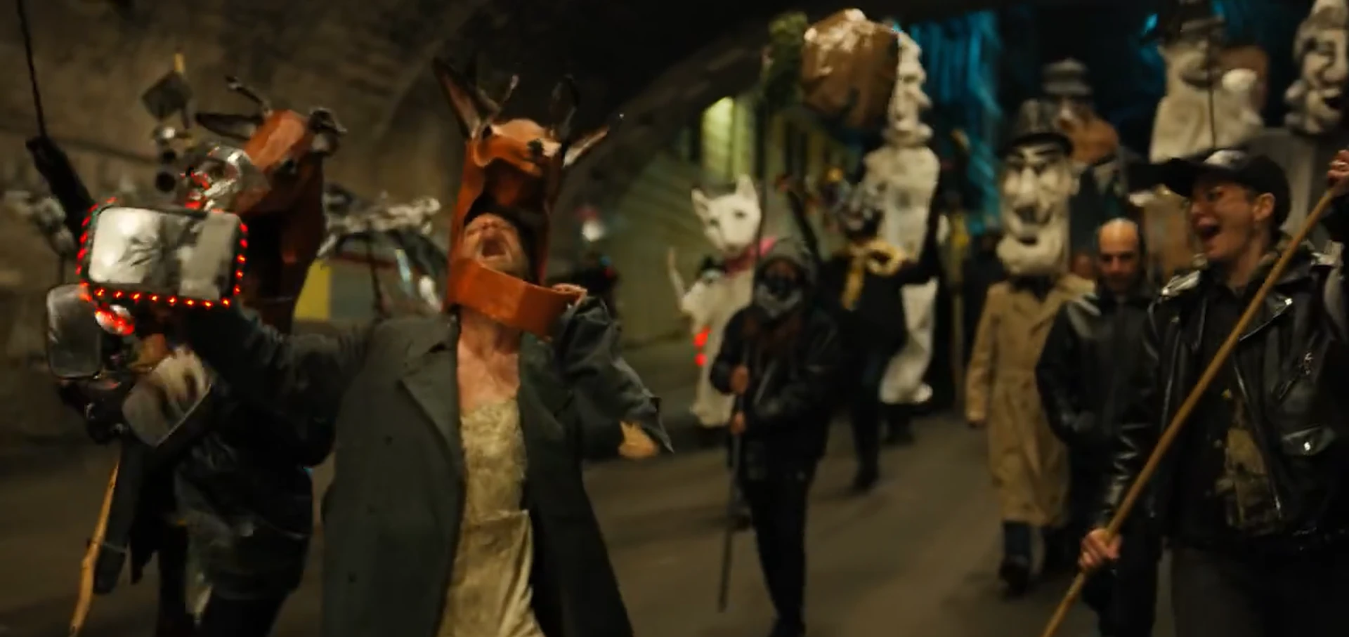 Horse leading a procession of masked revelers.